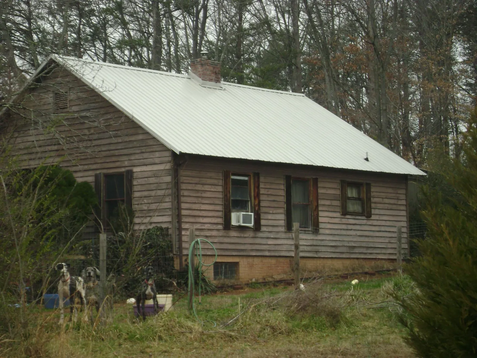 White metal roof on an old wood sided farmhouse, from a Metal Roof Installation job in Sunny Side